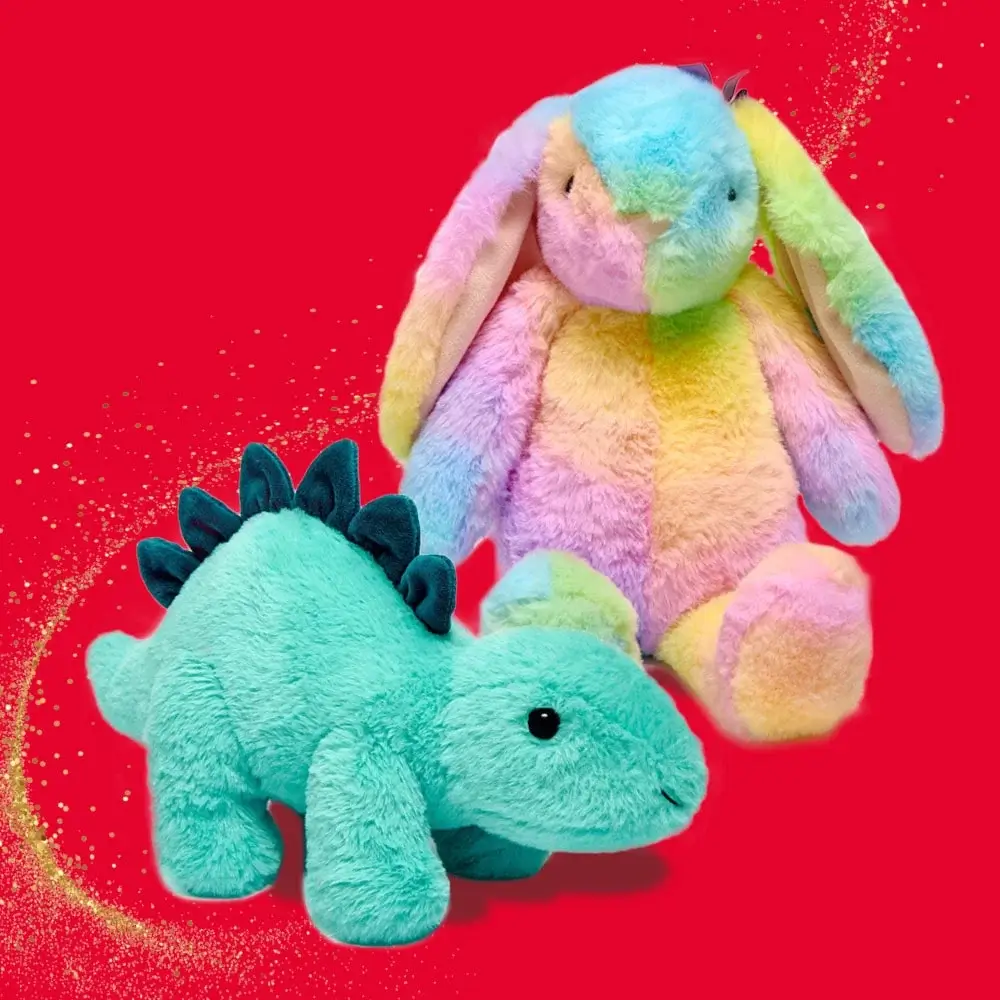 Two plush toys on a red background, one is a rainbow-colored bunny with long ears and the other is a teal dinosaur with dark blue spikes.